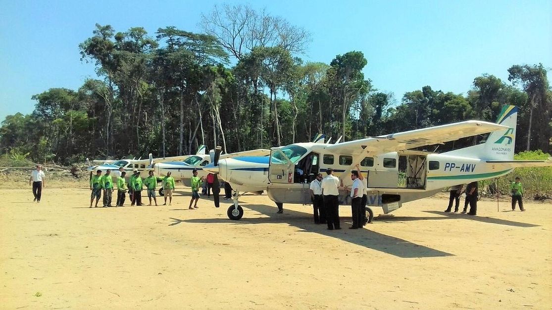 A charter aircraft on the sand strip beside the river
